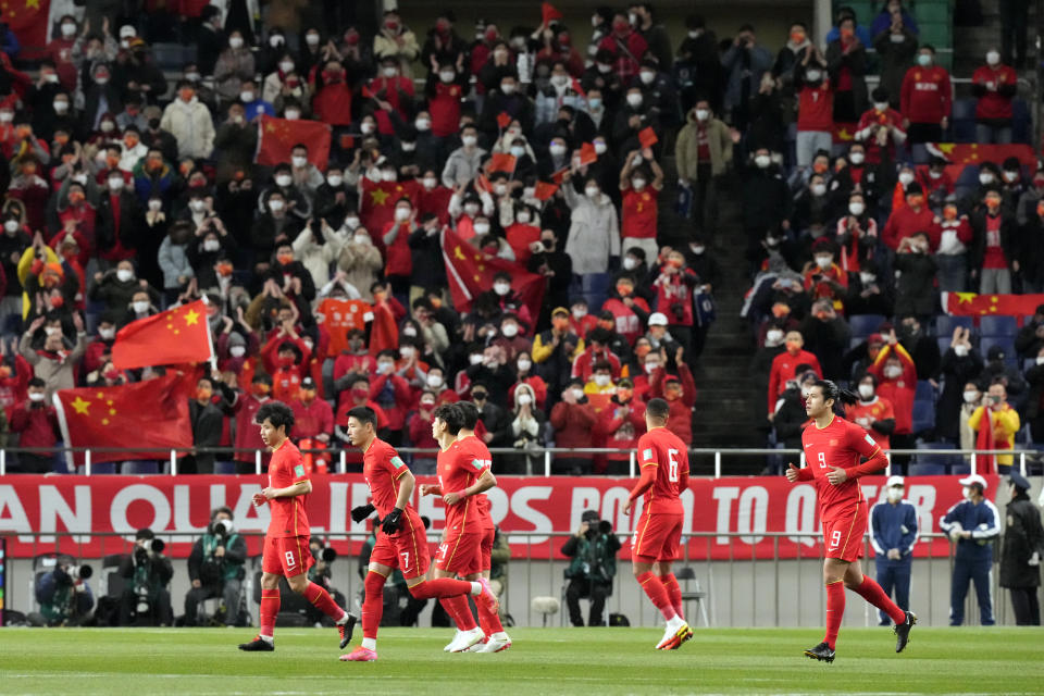 FILE - Chinese players prepare for kick off the World Cup 2022 group B qualifying soccer match against Japan at Saitama Stadium 2002 in Saitama, north of Tokyo, Thursday, Jan. 27, 2022. China is missing out on the World Cup again despite spending millions — probably billions — to develop the game, a reported priority of Xi Jinping, the all-powerful general secretary of the Chinese Communist Party. (AP Photo/Eugene Hoshiko, File)