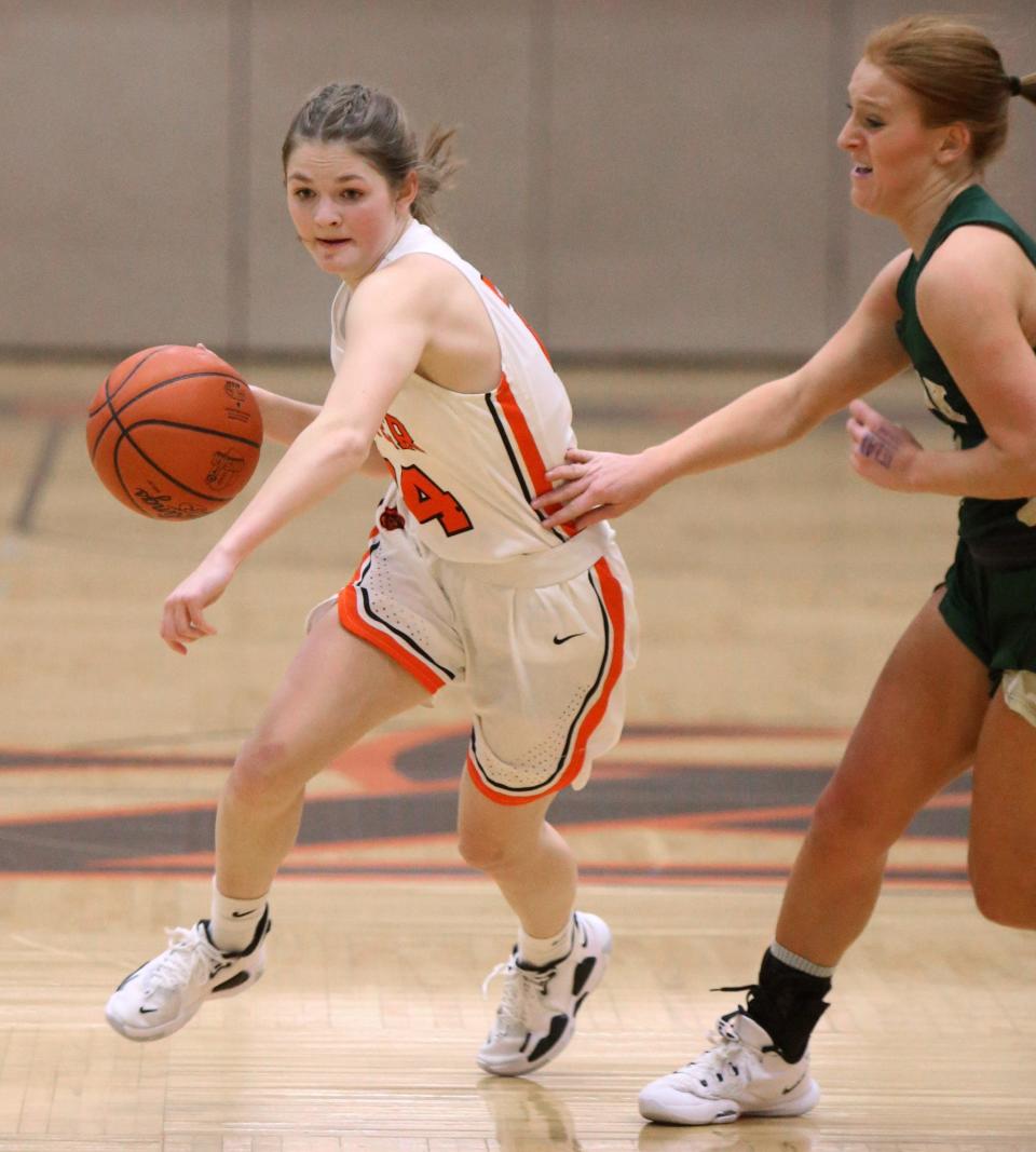 Regann Jefferies, left, of Hoover brings the ball upcourt while being defended by Keely Burke, 21, of GlenOak during their game at Hoover on Saturday.