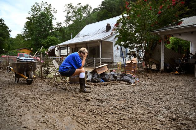 Teresa Reynolds sits exhausted as members of her community clean the debris from their flood ravaged homes at Ogden Hollar in Hindman, Kentucky, on July 30. (Photo: Timothy D. Easley/AP)