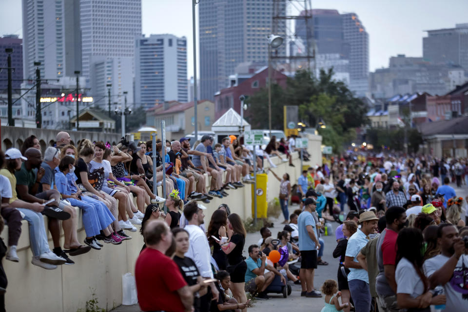 A crowd gathers as the Krewe of Boo parades in New Orleans Saturday, Oct. 23, 2021. Witches, goblins and masked creatures took to the streets Saturday night in the city’s first large, float parade since the pandemic ended such frivolity. (Scott Threlkeld/The Times-Picayune/The New Orleans Advocate via AP)