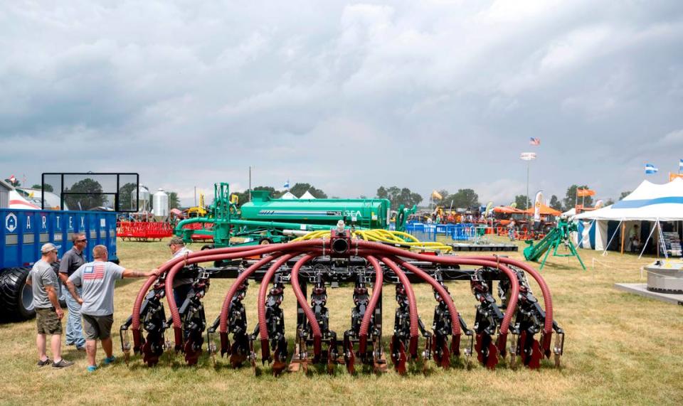 Visitors gather to learn about farm equipment on the first day of Penn State’s Ag Progress Days, Tuesday, Aug. 9, 2022.