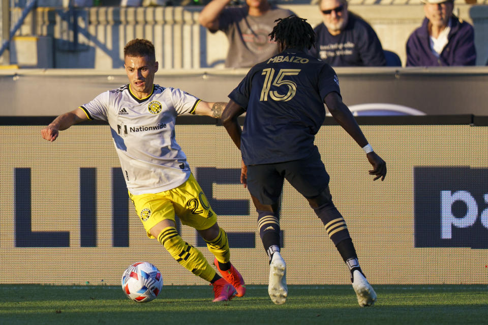 Columbus Crew's Alexandru Matan, left, makes his move against Philadelphia Union's Olivier Mbaizo, left during the first half of an MLS soccer match, Wednesday, June 23, 2021, in Chester, Pa. (AP Photo/Chris Szagola)