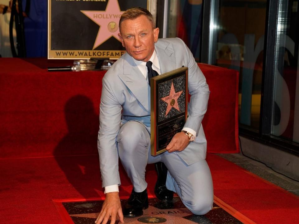 Daniel Craig poses atop his new star on the Hollywood Walk of Fame (Chris Pizzello/Invision/AP)