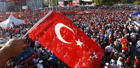 A man waves Turkey's national flag as he with supporters of various political parties gathers in Istanbul's Taksim Square during the Republic and Democracy Rally organised by main opposition Republican People's Party (CHP), Turkey, July 24, 2016. REUTERS/Osman Orsal