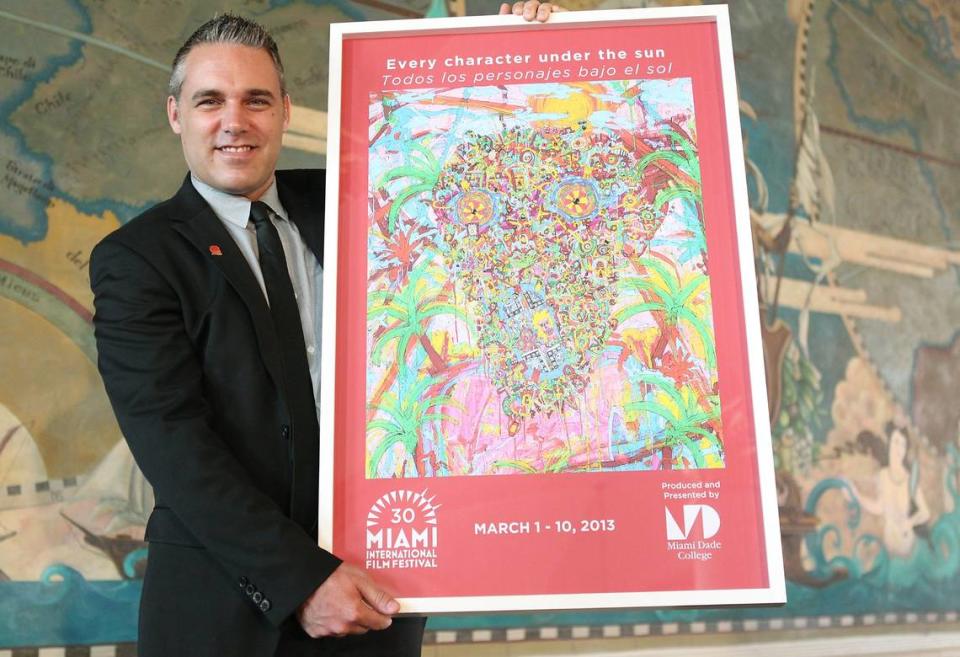 Jaie Laplante shows off a poster for the Miami Film Festival in 2013.