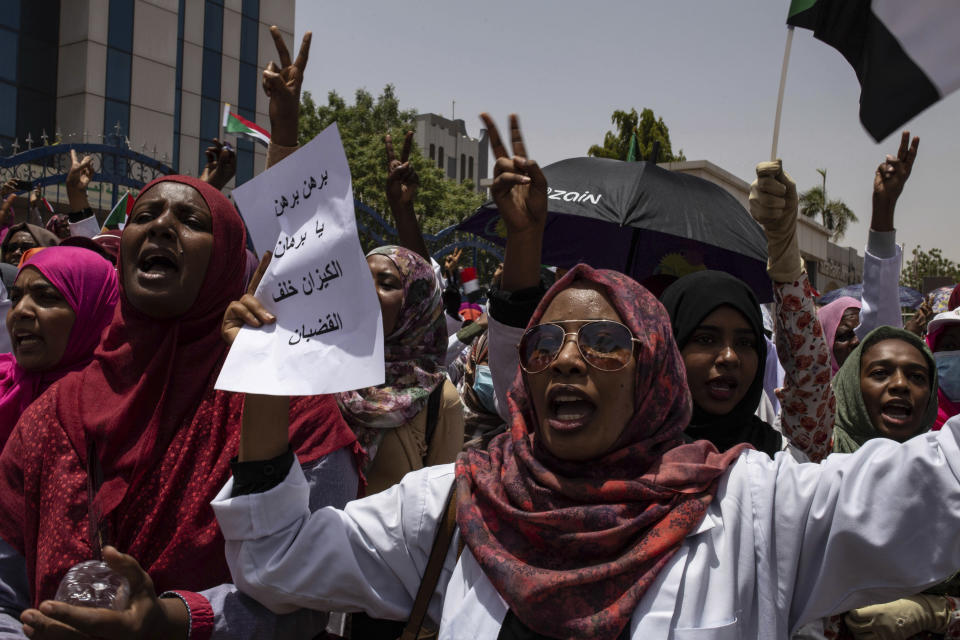 A group of protesters from the Sudanese medical profession syndicate march at the sit-in inside the Armed Forces Square, in Khartoum, Sudan, Wednesday, April 17, 2019. A Sudanese official and a former minister said the military has transferred ousted President Omar al-Bashir to the city's Kopar Prison in Khartoum. The move came after organizers of the street protests demanded the military move al-Bashir to an official prison. (AP Photos/Salih Basheer)