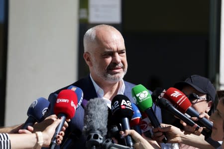 Albania's Prime Minister Edi Rama speaks to the media as he arrives at the polling station near Tirana