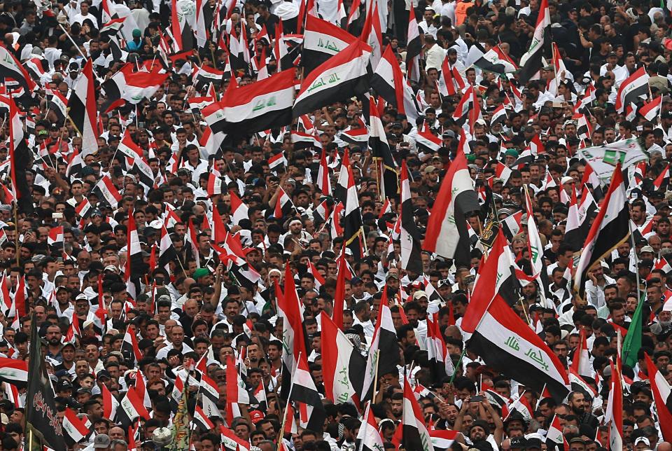 Followers of Shiite cleric Moqtada Al Sadr chant slogans against corruption, the U.S. and Israel during demonstrations between the holy shrines of Imam Hussein and Imam Abbas on the Arbaeen Shiite festival in Karbala, Iraq, Saturday, Oct. 19, 2019. The holiday marks the end of the forty-day mourning period after the anniversary of the martyrdom of Imam Hussein, the Prophet Muhammad's grandson in the 7th century. (AP Photo/Hadi Mizban)