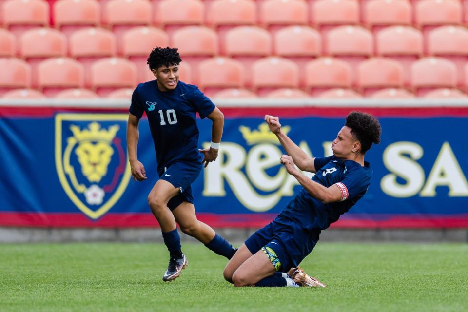Juan Diego Catholic’s Hauroa Margant (9) celebrates with teammate Danny Gutierrez (10) after scoring on a free kick during the 3A boys soccer championship game at America First Field in Sandy on May 12, 2023. | Ryan Sun, Deseret News
