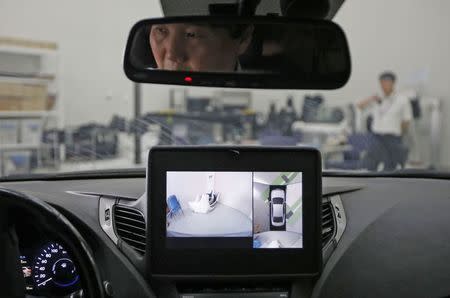 A researcher demonstrates an all around view system at Hyundai Mobis Research Centre in Yongin, in this file photo taken July 16, 2014. REUTERS/Kim Hong-Ji