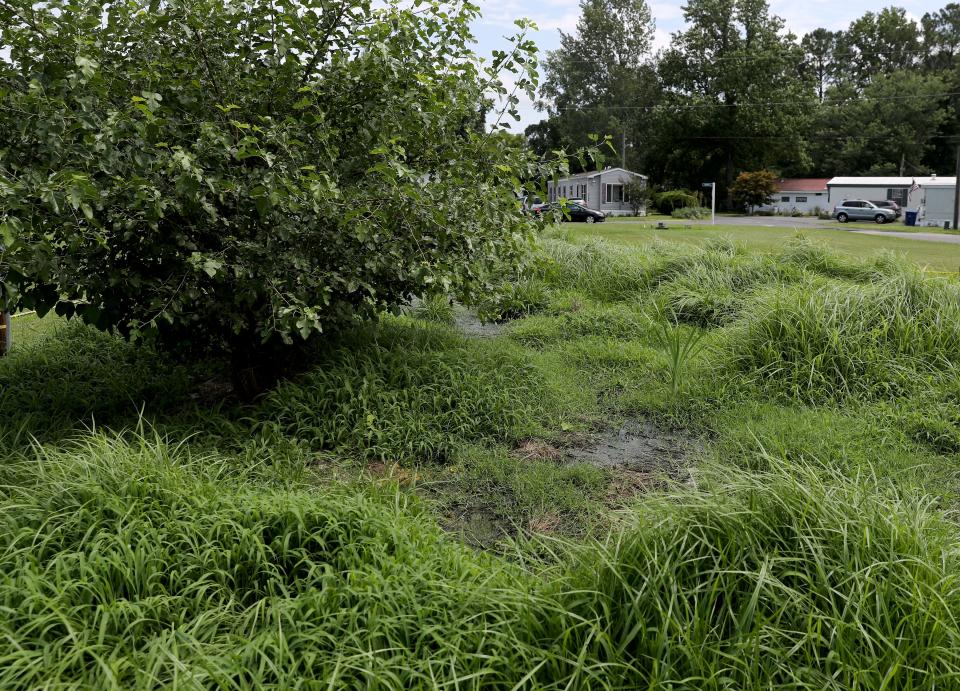 Pools of untreated wastewater are blocked off with caution tape July 9 at Donovan Smith Mobile Home Park in Lewes, Del.