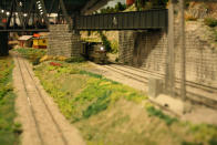 A trains pulls unter a bridge. After 67 years in the Liberty Village location, The Model Railroad Club of Toronto will be moving to make way for a condo.