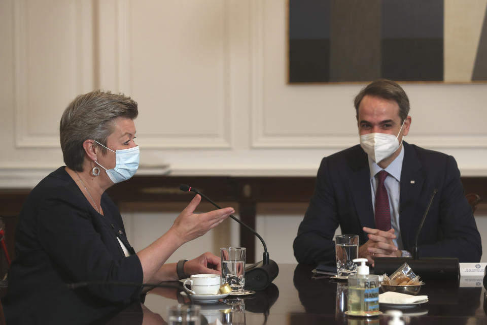 European Commissioner for Home Affairs Ylva Johansson, left, speaks with Greek Prime Minister Kyriakos Mitsotakis, during their meeting in Athens , on Tuesday , March 30, 2021. Johansson stressed the need for solidarity among the bloc's member states in tackling migration, and called on Turkey to resume accepting the return of people whose asylum applications are rejected in Greece after arriving from Turkey. (AP Photo/Petros Giannakouris)