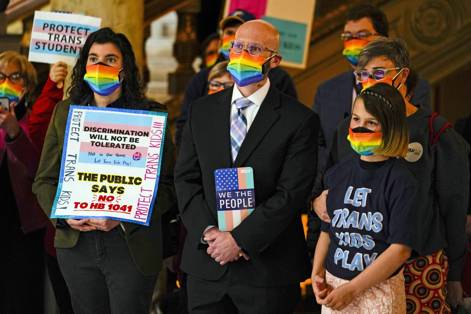 People gather to protest against HB1041, a bill to ban transgender women and girls from participating in school sports that match their gender identity, during a rally at the Statehouse in Indianapolis, Wednesday, Feb. 9, 2022. The Republican-backed bill drew nearly three hours of testimony on Wednesday, as lawmakers considered whether to further advance the bill. (AP Photo/Michael Conroy)