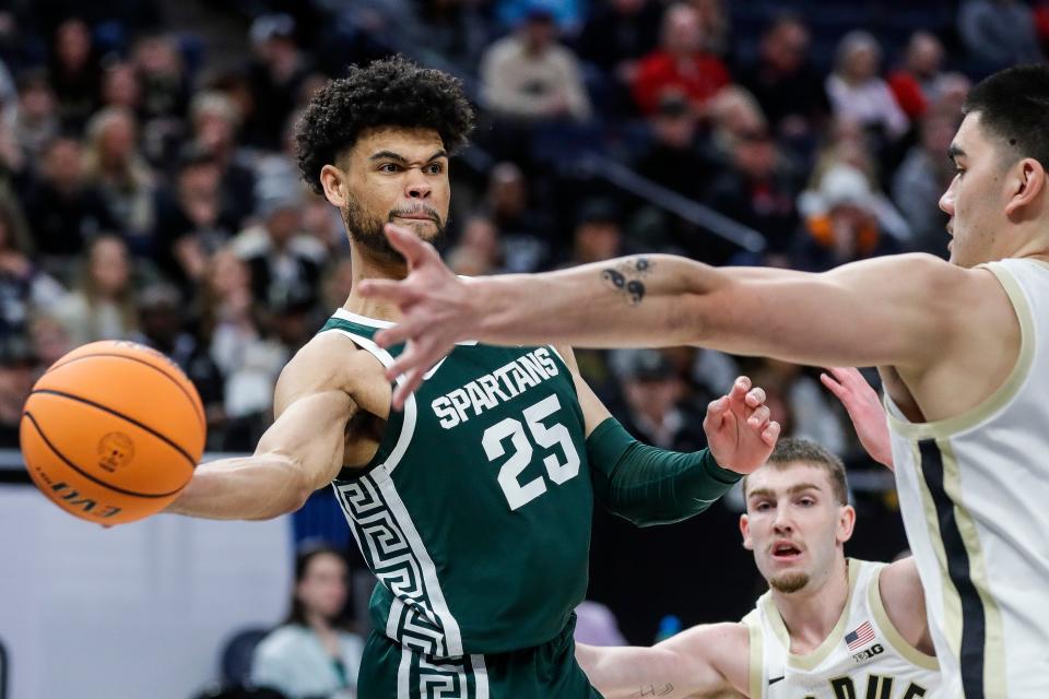 Michigan State forward Malik Hall (25) makes a pass against Purdue center Zach Edey (15) during the first half of quarterfinal of Big Ten tournament at Target Center in Minneapolis, Minn. on Friday, March 15, 2024.