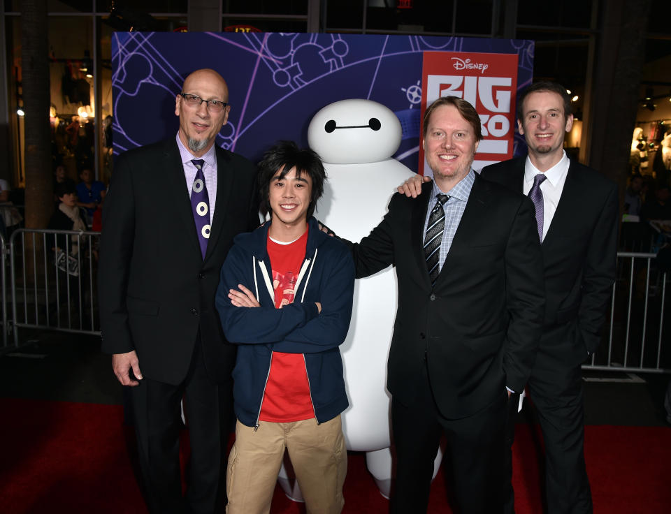 HOLLYWOOD, CA - NOVEMBER 04:  (L-R) Producer Roy Conli, directors Don Hall and Chris Williams with characters Hiro and Baymax attend the premiere of Disney's "Big Hero 6" at the El Capitan Theatre on November 4, 2014 in Hollywood, California.  (Photo by Kevin Winter/Getty Images)