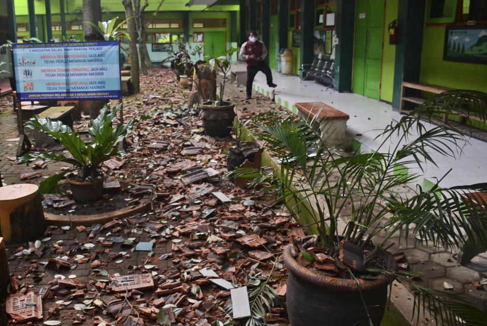 Pieces of roof tiles and other debris litter the ground at a school following an earthquake in Malang, East Java, Indonesia, Saturday, April 10, 2021. A strong earthquake damaged buildings on Indonesia's main island of Java and shook the tourist hotspot of Bali, officials said Saturday. No tsunami warnings were posted. (AP Photo/Hendra Permana)