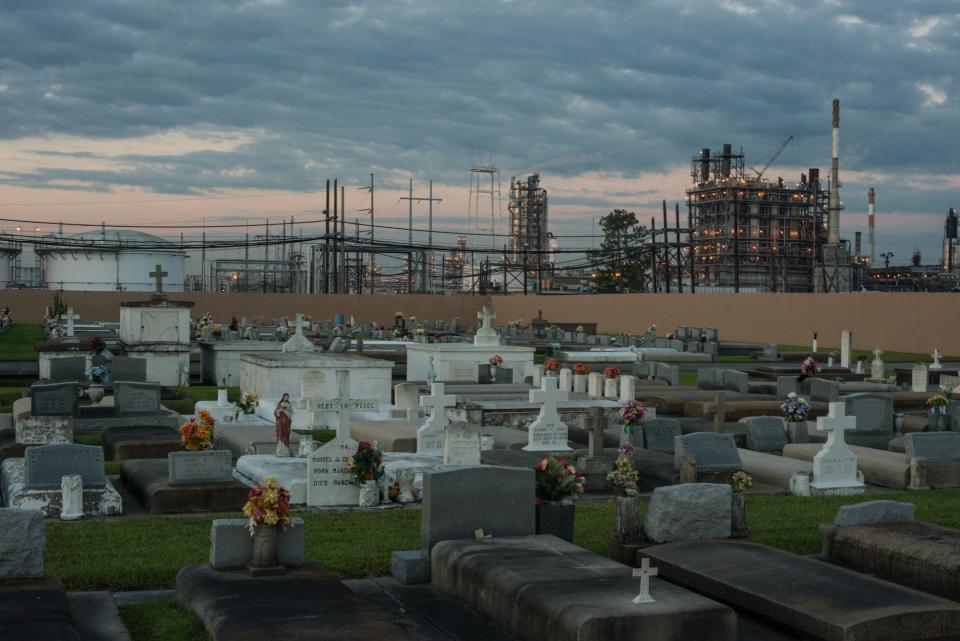 A cemetery stands in stark contrast to the chemical plants that surround it October 15, 2013