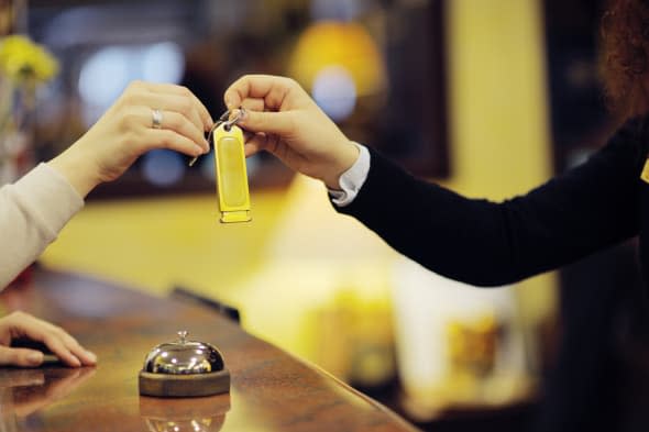 business woman  at the reception of a hotel checking in