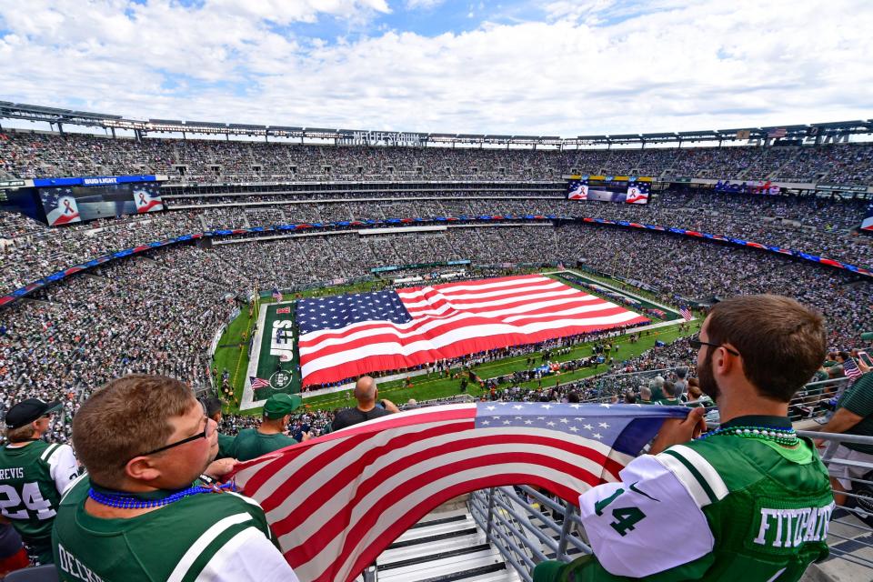 <p>Fans hold an American flag during the National Anthem prior to the game between the New York Jets and the Cincinnati Bengals at MetLife Stadium on September 11, 2016 in East Rutherford, New Jersey. (Photo by Steven Ryan/Getty Images) </p>