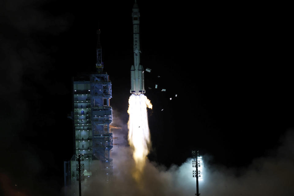 The crewed spaceship Shenzhou-13, atop a Long March-2F carrier rocket, is launched from the Jiuquan Satellite Launch Center in northwest China's Gobi Desert, Oct. 16, 2021 (Chinatopix Via AP)