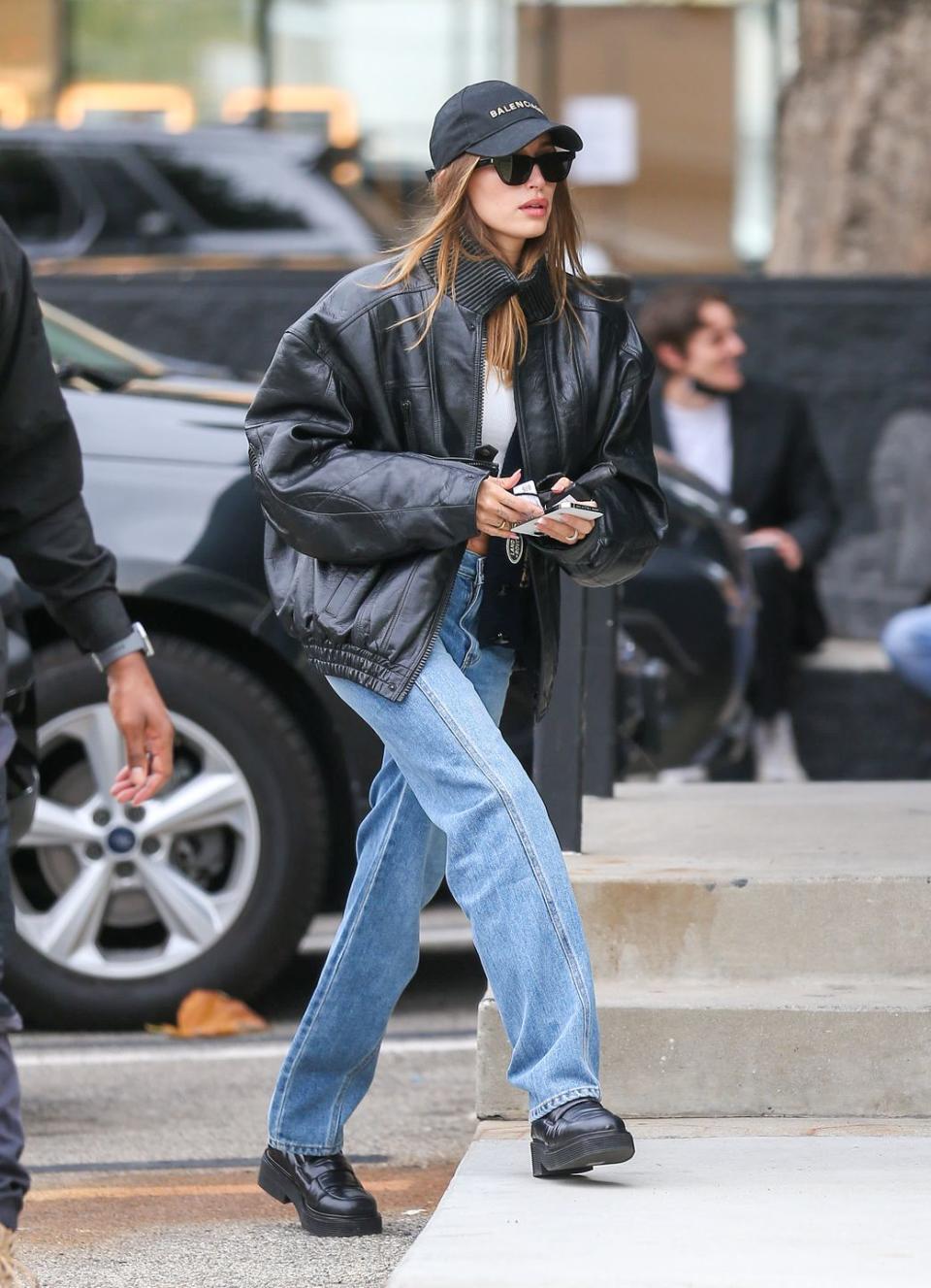 <p>The model looked effortlessly cool in baggy jeans, a white crop top and leather bomber jacket topped with a Balenciaga logo cap while out and about in Los Angeles.</p>