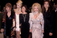 <p>Parton and an all-star cast consisting of Shirley MacLaine, Daryl Hannah, Sally Fields, and Julia Roberts shine at an event promoting <em>Steel Magnolias. </em>An all-white, beaded dress ensures Dolly stands out like no one else. </p>