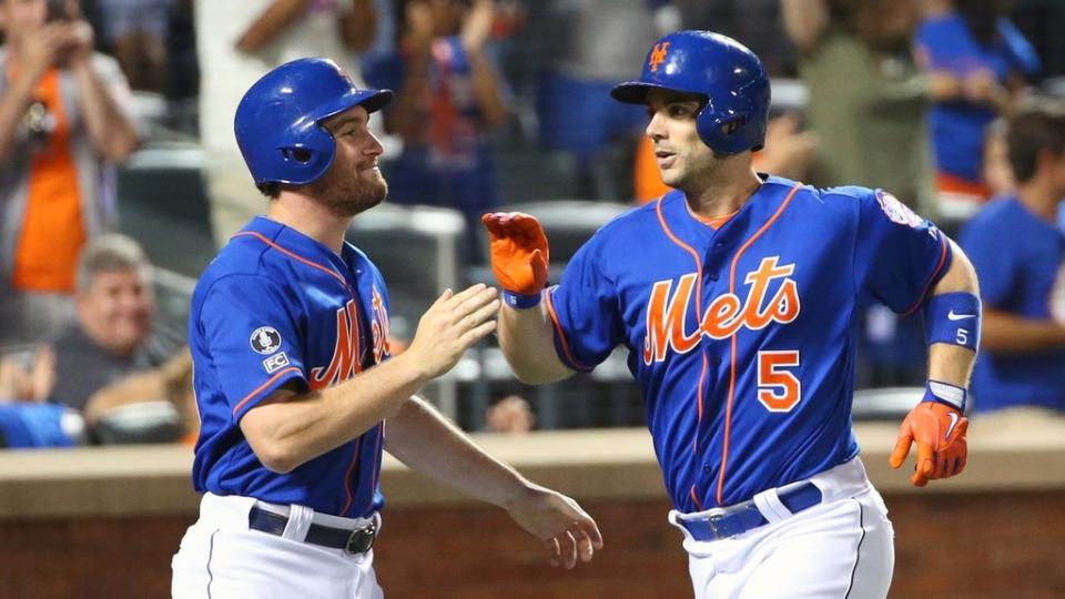 Jul 11, 2014; New York, NY, USA; New York Mets second baseman Daniel Murphy (28) and third baseman David Wright (5) celebrate scoring during the fifth inning against the Miami Marlins at Citi Field.