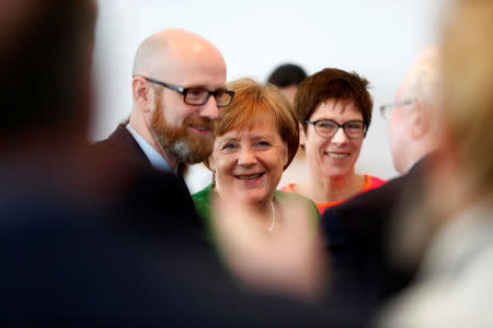 Secretary General of the Christian Democratic Union (CDU) Peter Tauber, German Chancellor Angela Merkel and Saarland State Prime Minister Annegret Kramp-Karrenbauer ahead CDU leadership meeting in Berlin, Germany, February 19, 2018. REUTERS/Hannibal Hanschke