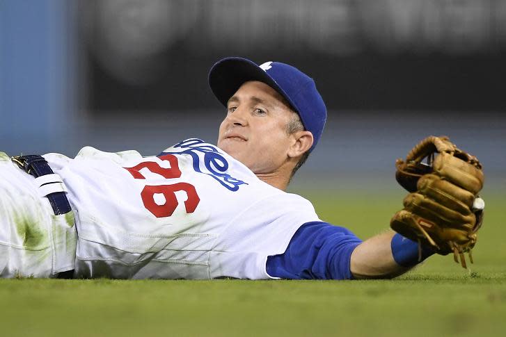 Dodgers second baseman Chase Utley cracks a smile after completing a diving play from flat on his back. (AP)