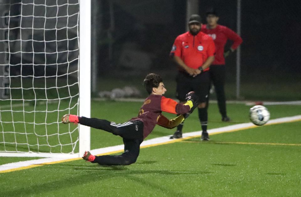 London goalkeeper Giovanni Scanio dives to stop a penalty kick in the shootout of the Pirates 1-0 win against IDEA North Mission in the Class 4A boys bi-district soccer playoffs at Cabaniss East on Thursday, March 23, 2023.