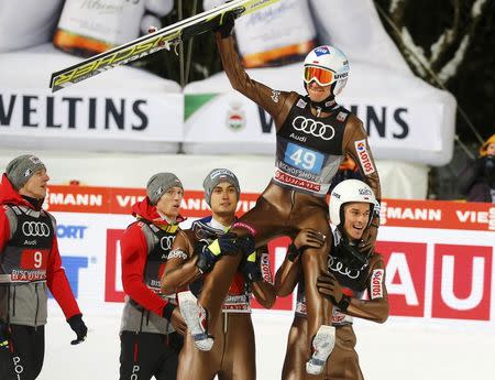 Ski Jumping - 65th four-hills ski jumping tournament final round - Bischofshofen, Austria - 06/01/2017 - Poland's Kamil Stoch celebrates among his compatriots after winning the 65th four-hills tournament. REUTERS/Dominic Ebenbichler