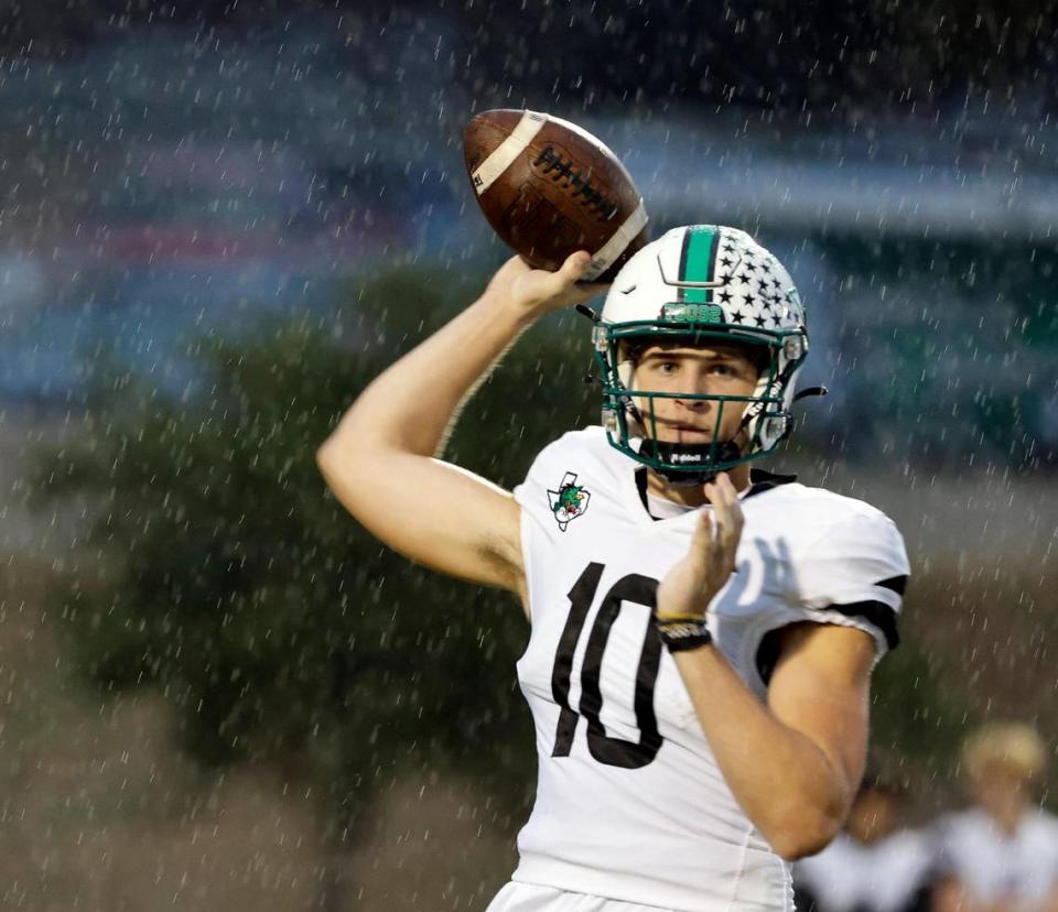 Carroll quarterback Graham Knowles (10) makes a sidelines toss in the rain in the first half of a UIL high school football game at Keller ISD Stadium in Keller, Texas, Thursday, Sept. 14, 2023. Bob Booth/Special to the Star-Telegram