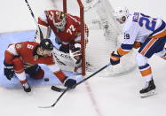 Florida Panthers goaltender Sergei Bobrovsky (72) stops a wrap-a-round attempt from New York Islanders center Brock Nelson (29) as defenseman Anton Stralman (6) keeps close during the first period of an NHL Stanley Cup playoff hockey game in Toronto, Ontario, Wednesday, Aug. 5, 2020. (Nathan Denette/The Canadian Press via AP)