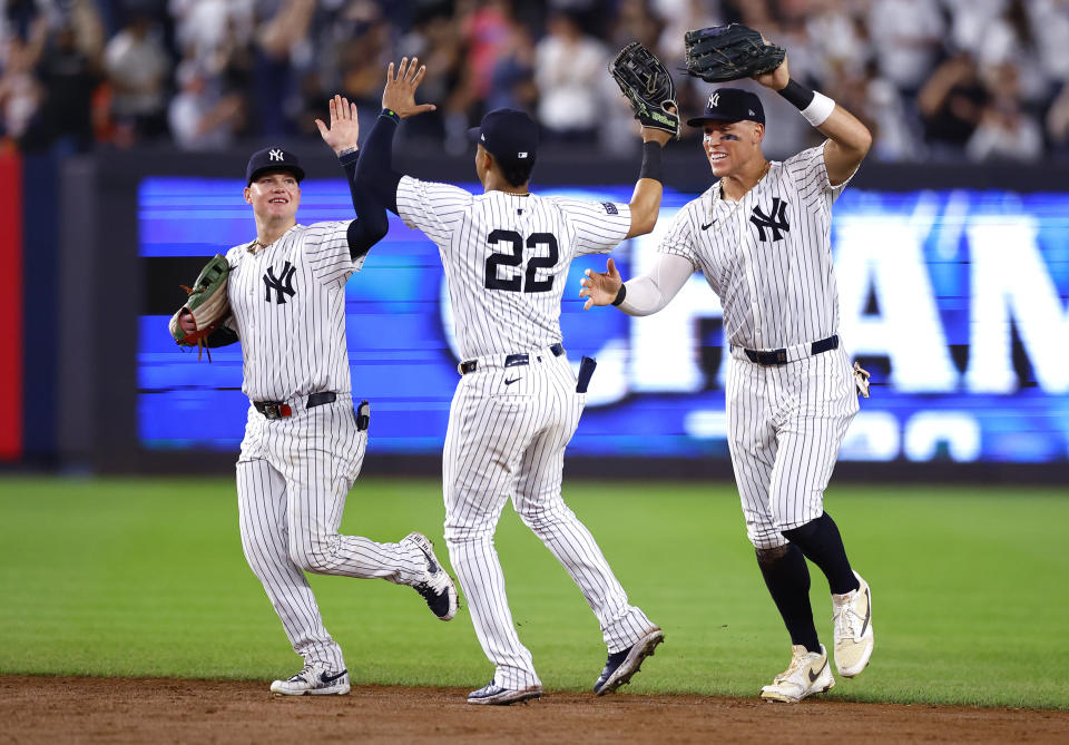 From left to right, New York Yankees' Alex Verdugo, Juan Soto and Aaron Judge celebrate after clinching the American League East title in a baseball game against the Baltimore Orioles, Thursday, Sept. 26, 2024, in New York. (AP Photo/Noah K. Murray)