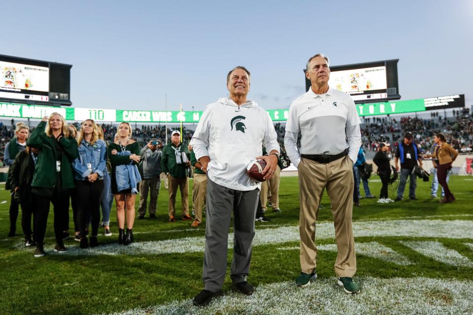 Sept. 28, 2019: Michigan State 40, Indiana 31, Spartan Stadium: Mark Dantonio watches a video on the scoreboard next to basketball coach Tom Izzo to celebrate his program record for wins. The record was set the week prior on the road.