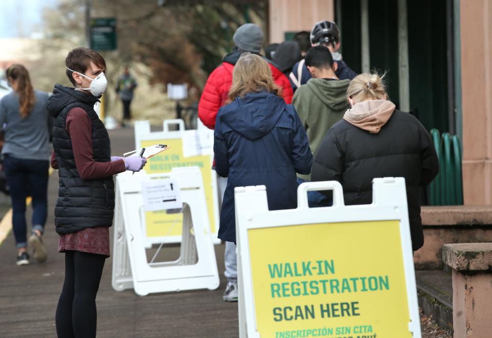 People line up for mild-symptom COVID-19 testing at a clinic recently set up by the University of Oregon at McArthur Court on campus.