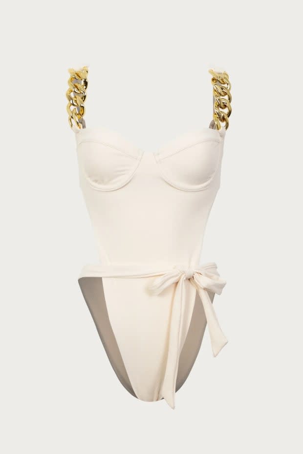 <p>Same Gold Chain One Piece, $285, <a href="https://www.samelosangeles.com/products/gold-chain-one-piece-faux-suede-cream?variant=43860022100246" rel="nofollow noopener" target="_blank" data-ylk="slk:available here;elm:context_link;itc:0;sec:content-canvas" class="link ">available here</a> (sizes XS-L)</p>