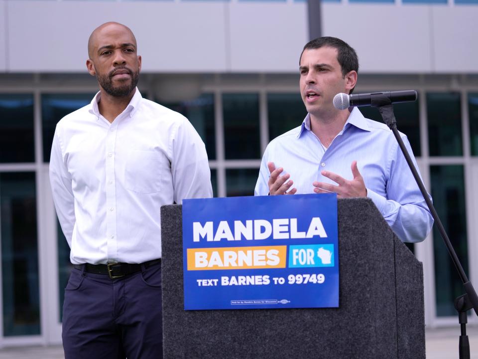 Milwaukee Bucks executive Alex Lasry, right, speaks next to Lt. Gov. Mandela Barnes during a news conference at Deer District Plaza in Milwaukee on Wednesday. With less than two weeks before the primary, Lasry announced on Wednesday he was dropping out of the Democratic U.S. Senate race, and endorsing the front-runner, Barnes.
