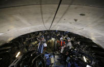 Engineers work on a 140-meter-long rock-eating machine dubbed 'Federica' in a Turin-Lyon high-speed rail tunnel (TAV) in Saint Martin La Porte, France, Tuesday, Feb. 12, 2019. The project is part of a European wide network to improve high-speed rail connections. On the Italian side, the construction site long targeted by sabotaging protesters is guarded by four law enforcement agencies and has been reduced to maintenance work only. The survival of Italy's increasingly uneasy populist government could very well depend on whether Italy restarts construction on the TAV link, which it halted in June. (AP Photo/Antonio Calanni)