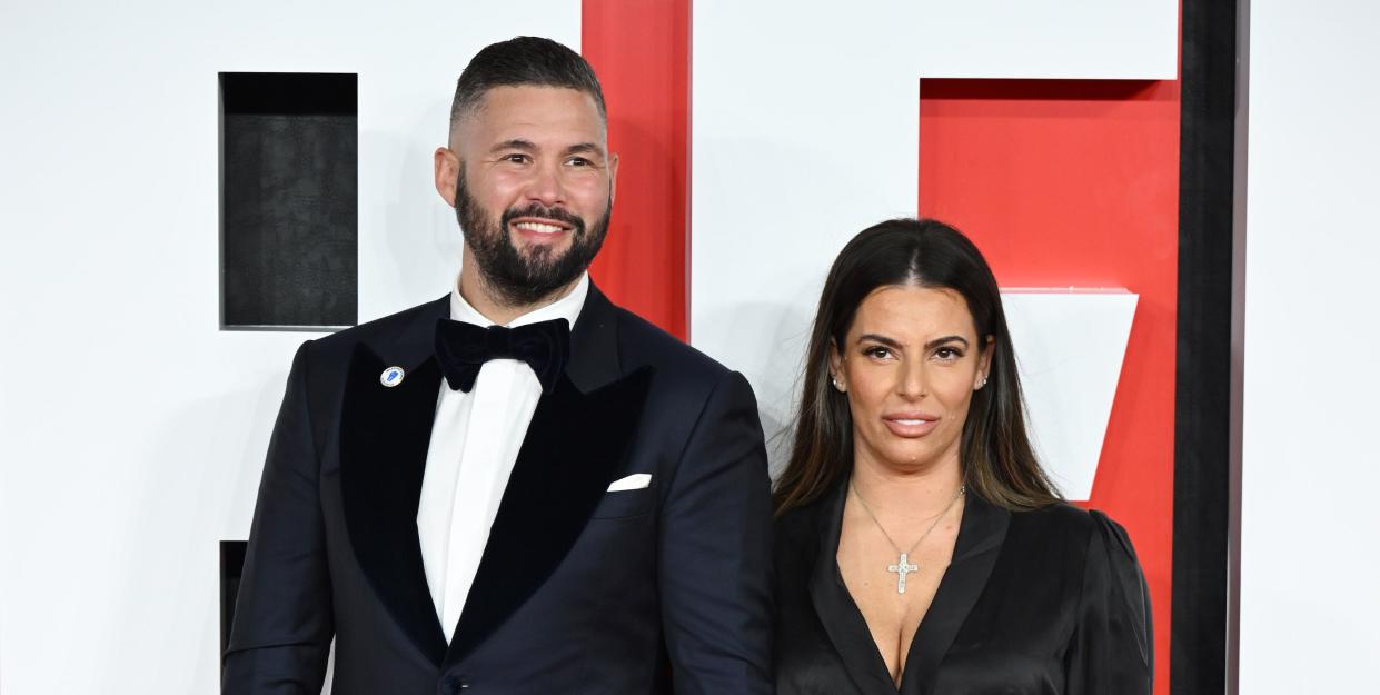 tony bellew and wife rachael roberts stand together, with tony in a black suit and rachael in a black dress