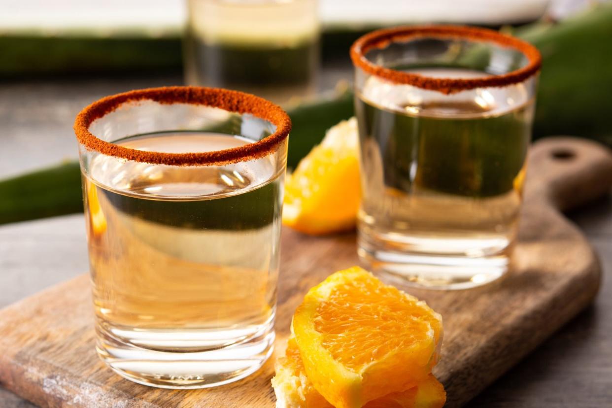 Mezcal Mexican drink with orange slices and worm salt