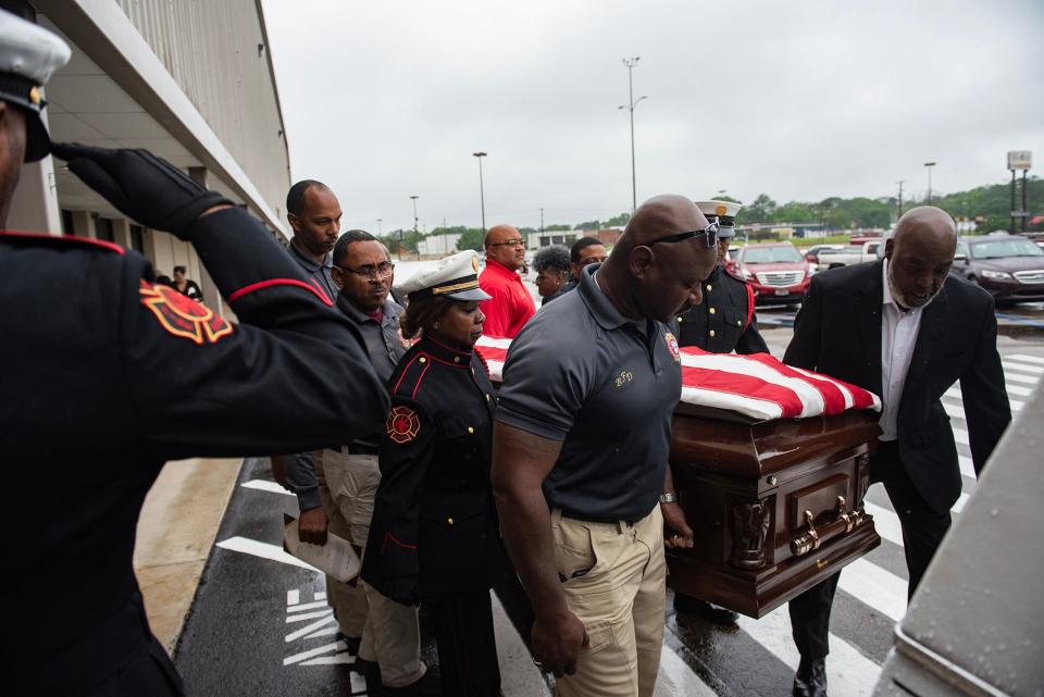 The casket of veteran firefighter Gerald Bates is put into a hearse for transport to the burial after the service at New Horizon Church International in Jackson, Miss, on Saturday, April 20, 2024.