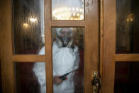 Disinfection team disinfect the premises of the grand mosque in capital Pristina, Kosovo on Thursday, May 28, 2020. Kosovo's mosques reopened on Thursday after more than two months of the virus lockdown. (AP Photo/Visar Kryeziu)