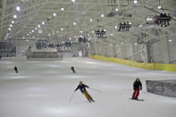 Snowboarders and skiers enjoy the grand opening of Big Snow in East Rutherford, N.J., Thursday, Dec. 5, 2019. The facility, which is part of the American Dream mega-mall, is North America's first indoor ski and snowboard slope with real snow. (AP Photo/Seth Wenig)