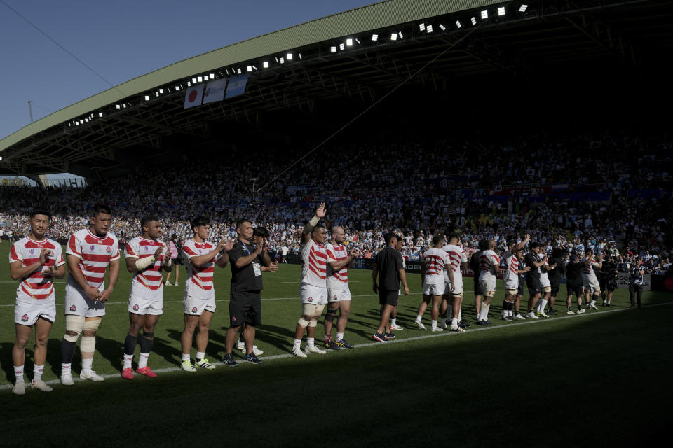 Japan players wave to fans at the end of the Rugby World Cup Pool D match between Japan and Argentina at the Stade de la Beaujoire in Nantes, western France, Sunday, Nov. 8, 2023. (AP Photo/Lewis Joly)