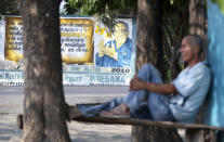 A man rests across the street from a mural of Nobel laureate Gabriel Garcia Marquez in Aracataca, the city were he was born in Colombia's Caribbean coast, Friday, April 18, 2014. Garcia Marquez died in Mexico City on April 17, 2014. (AP Photo/Ricardo Mazalan)