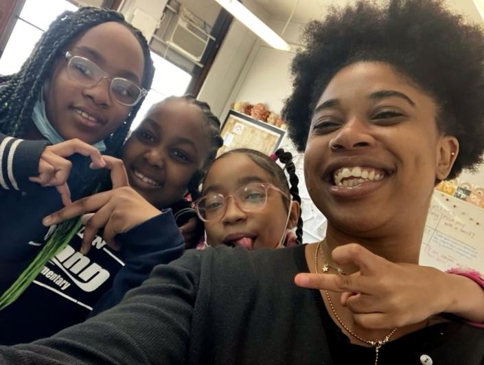 Selfie of Atiyah Harmon smiling with her students