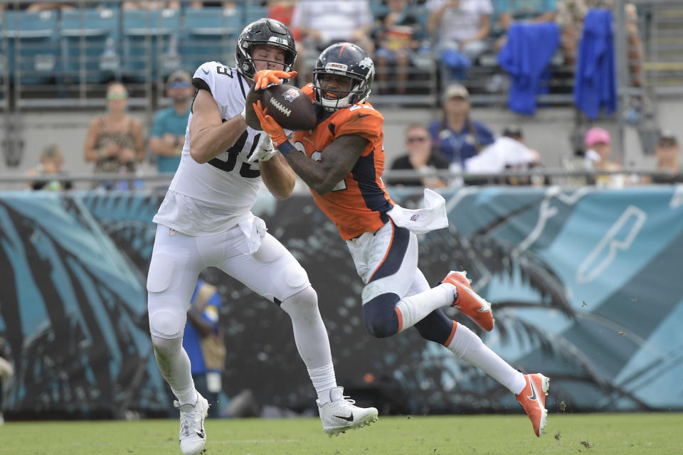 Denver Broncos safety Kareem Jackson, right, intercepts a pass in front of Jacksonville Jaguars tight end Luke Farrell during the second half of an NFL football game, Sunday, Sept. 19, 2021, in Jacksonville, Fla. (AP Photo/Phelan M. Ebenhack)