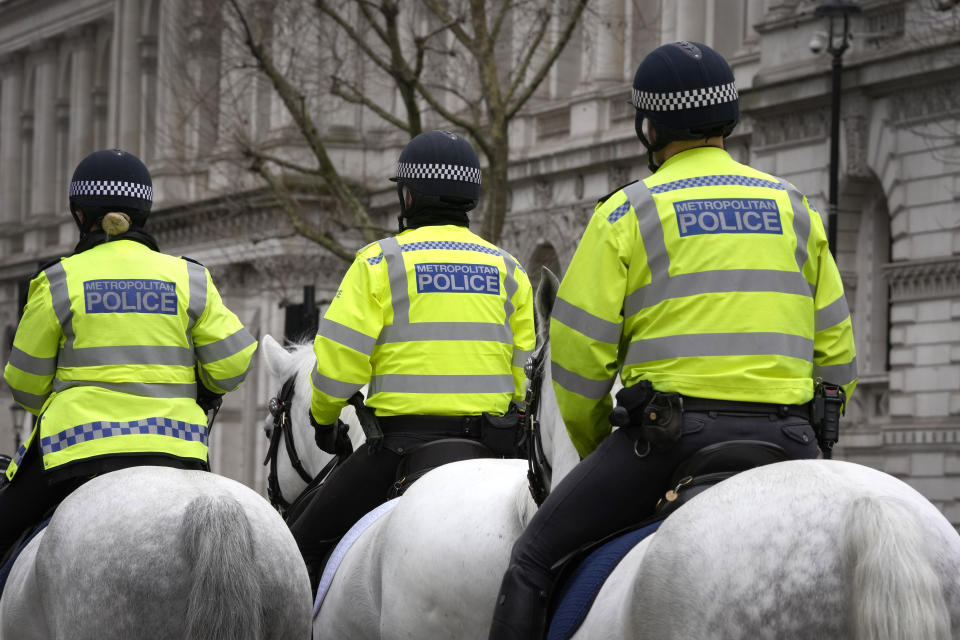 Police officers ride in Westminster in London, Tuesday, March 21, 2023. An independent review says London police have lost the confidence of the public because of deep-seated racism, misogyny and homophobia. The report released Tuesday was commissioned after a young woman was raped and killed by a serving officer. (AP Photo/Kirsty Wigglesworth)